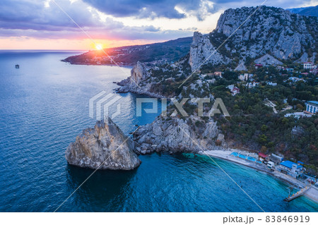 Aerial view of Simeiz village, Diva rock in sunset light. Cat mountain in background, Crimea. Black Sea Aerial view of Simeiz village, Diva rock in sunset light. Cat mountain in background, Crimea. Black Sea 83846919