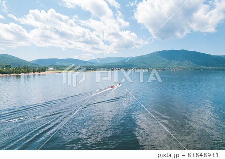 Summertime imagery of Lake Baikal is a rift lake located in southern Siberia, Russia Baikal lake summer landscape view from a cliff near Grandma's Bay. Drone's Eye View. 83848931