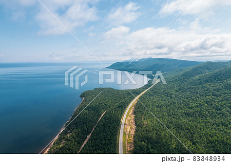 Summertime imagery of Lake Baikal is a rift lake located in southern Siberia, Russia Baikal lake summer landscape view from a cliff near Grandma's Bay. Drone's Eye View. 83848934