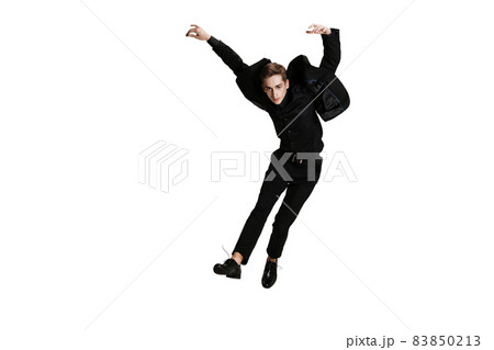 Young man in black business suit dancing isolated on white background. Art, motion, action, flexibility, inspiration concept. 83850213
