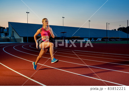Runner sprinting towards success on run path running athletic track. Goal achievement concept. 83852221