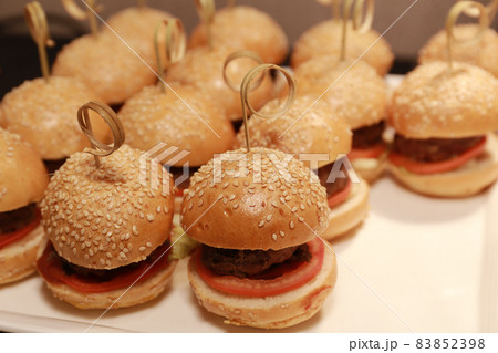 the Close up of appetizing mini beef hamburgers on at catering event. 83852398