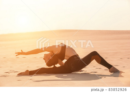 Side view of girl doing squats on grey background Side view of girl doing squats on grey background 83852926