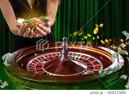 Collage of casino images with a close-up vibrant image of multicolored casino roulette table with poker chips in woman hands. Collage of casino images with a close-up vibrant image of multicolored casino roulette table with poker chips in woman hands. 83852986