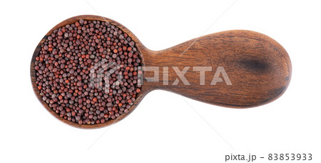 Black mustard seeds in wooden spoon, isolated on white background. Top view. Black mustard seeds in wooden spoon, isolated on white background. Top view. 83853933