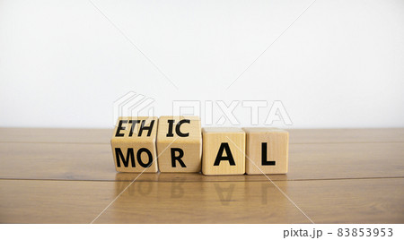 Ethical or moral symbol. Turned wooden cubes and changed the word 'moral' to 'ethical' on a beautiful wooden table, white background. Business and ethical or moral concept. Copy space. Ethical or moral symbol. Turned wooden cubes and changed the word 'moral' to 'ethical' on a beautiful wooden table, white background. Business and ethical or moral concept. Copy space. 83853953