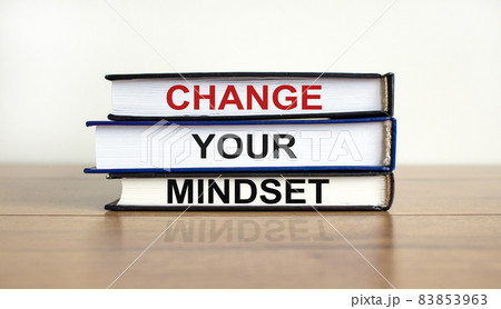 Books with text 'change your mindset' on beautiful wooden table, white background. Business concept. Copy space. 83853963
