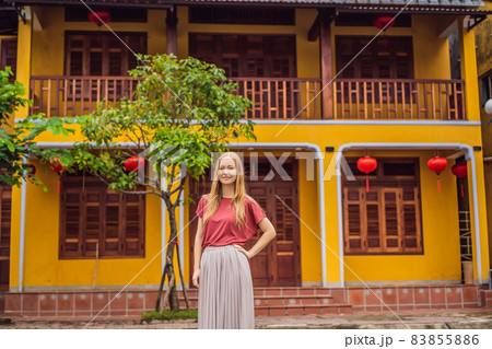 Woman tourist on background of Hoi An ancient town, Vietnam. Vietnam opens to tourists again after quarantine Coronovirus COVID 19 Woman tourist on background of Hoi An ancient town, Vietnam. Vietnam opens to tourists again after quarantine Coronovirus COVID 19 83855886