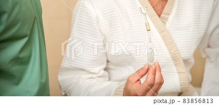 Young caucasian man receiving nasal inhalation Maholda with essential oil in the nose at a hospital. 83856813
