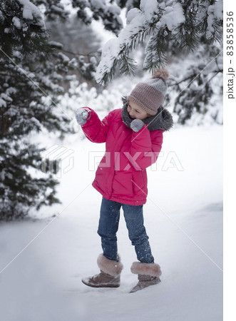 Child in winter. A little girl, playing in the winter outside. Child in winter. A little girl, playing in the winter outside. 83858536
