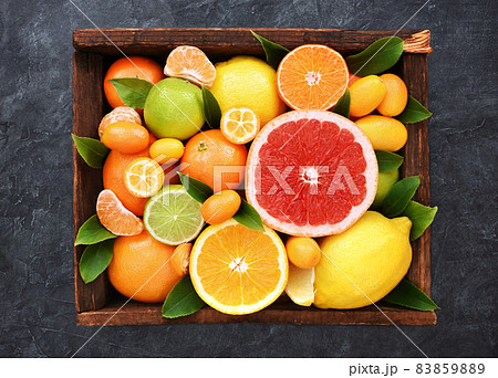 Colorful bright background of fresh ripe sweet citrus fruits: orange and red grapefruit, green lime and yellow lemon, tangerine and kumquat Colorful bright background of fresh ripe sweet citrus fruits: orange and red grapefruit, green lime and yellow lemon, tangerine and kumquat 83859889