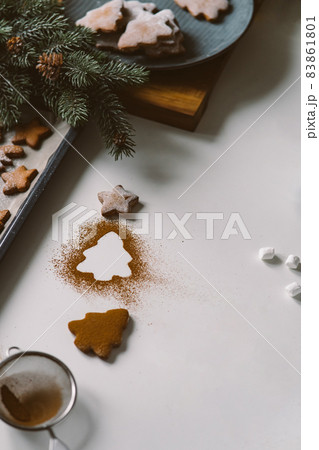 Kitchen table with gingerbread cookies and christmas decor, christmas tree 83861801