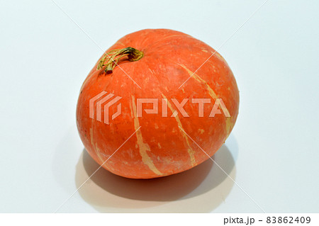 Ripe pumpkin lies on a white table. Ripe pumpkin lies on a white table. 83862409