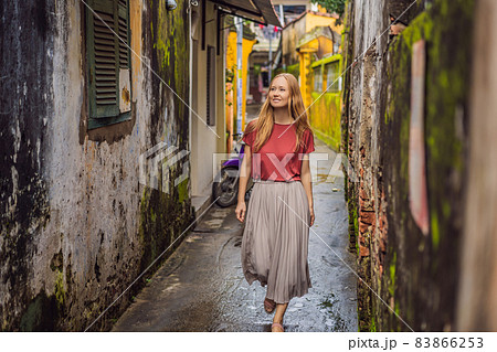 Woman tourist on background of Hoi An ancient town, Vietnam. Vietnam opens to tourists again after quarantine Coronovirus COVID 19 Woman tourist on background of Hoi An ancient town, Vietnam. Vietnam opens to tourists again after quarantine Coronovirus COVID 19 83866253