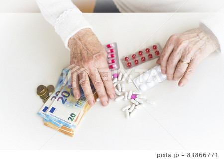 An older retired woman is counting money and saving it for medicines. An older retired woman is counting money and saving it for medicines. 83866771