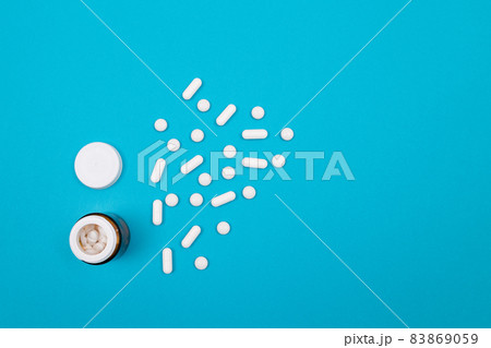 Pharmaceutical Industry and Medicinal Products - White Pills on Blue Table Pharmaceutical Industry and Medicinal Products - White Pills on Blue Table 83869059
