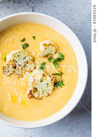 Vegetarian cream cheese soup with cauliflower in white bowl. Healthy vegan food concept. 83869326
