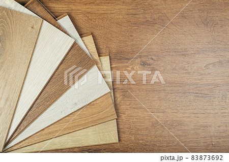 Laminate background. Samples of laminate or parquet with a pattern and wood texture for flooring and interior design. Production of wooden floors Laminate background. Samples of laminate or parquet with a pattern and wood texture for flooring and interior design. Production of wooden floors 83873692
