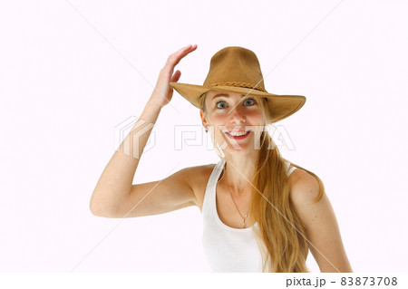 Close up portrait of smiling young woman with cowboy hat Close up portrait of smiling young woman with cowboy hat 83873708