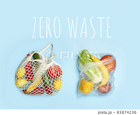 A reusable shopping string bag with vegetables and fruit from the supermarket. Single-use plastic bag ban concept. Zero waste background. High quality photo 83874236