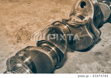 Black and White Side View Broken Crankshaft of Truck Engine on Ground Black and White Side View Broken Crankshaft of Truck Engine on Ground 83874784