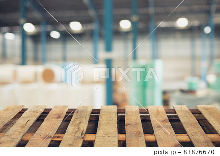 blur raw material warehouse storage zone with wooden pallet floor foreground for advertising montage background 83876670