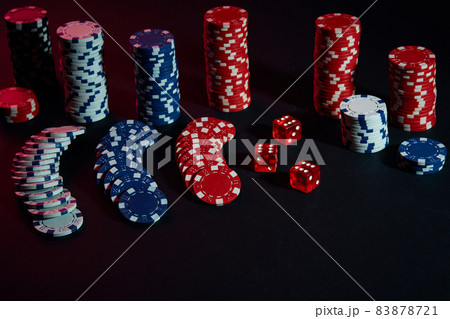Dice and chips on black background 83878721
