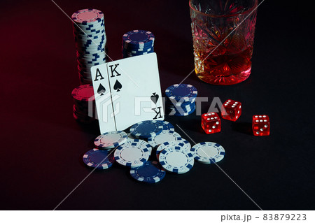 Cards of poker player. On the table are chips and a glass of cocktail with whiskey. Cards - Ace and King Cards of poker player. On the table are chips and a glass of cocktail with whiskey. Cards - Ace and King 83879223