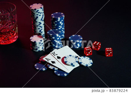 Cards of poker player. On the table are chips and a glass of cocktail with whiskey. Cards - Ace and King 83879224