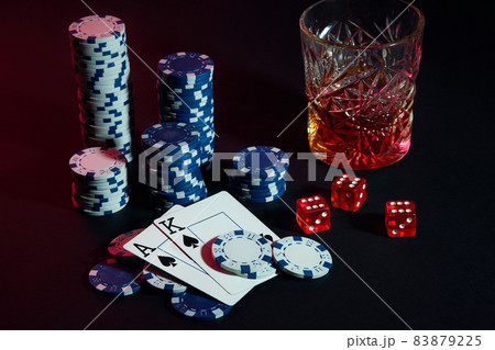 Cards of poker player. On the table are chips and a glass of cocktail with whiskey. Cards - Ace and King Cards of poker player. On the table are chips and a glass of cocktail with whiskey. Cards - Ace and King 83879225