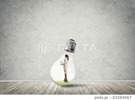 Businesswoman trapped in bulb 83884067