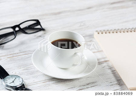 Top view office desk with white cup of coffee Top view office desk with white cup of coffee 83884069