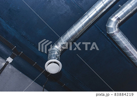 Ventilation pipe system at the ceiling of an industrial enterprise or plant premises Ventilation pipe system at the ceiling of an industrial enterprise or plant premises 83884219