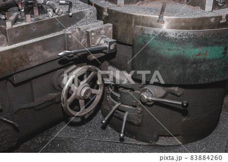 Old carousel machine tools and equipment for metalworking iron products in the workshop of an industrial plant 83884260