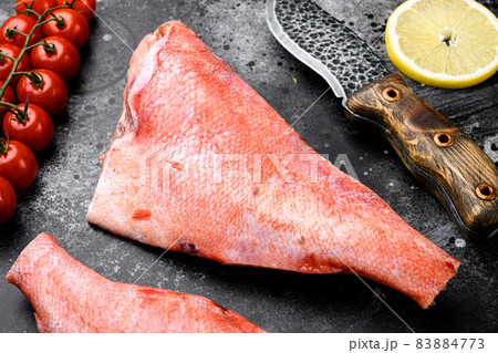 Fresh red perch or sea bass, on black dark stone table background 83884773