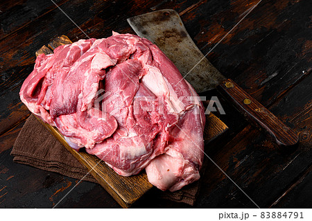 Raw lamb shoulder meat ready for baking, on old dark wooden table background 83884791