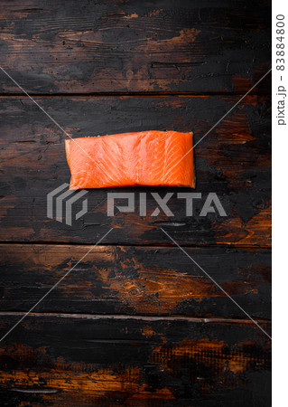 Raw salmon fillet fish meat, on old dark wooden table background, top view flat lay, with copy space for text 83884800