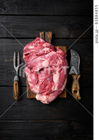 Fresh raw mutton shoulder meat, on black wooden table background, top view flat lay, with copy space for text 83884855