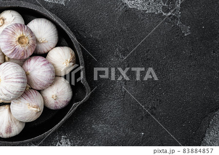 Bio garlic from bio herbs garden, on black dark stone table background, top view flat lay, with copy space for text Bio garlic from bio herbs garden, on black dark stone table background, top view flat lay, with copy space for text 83884857