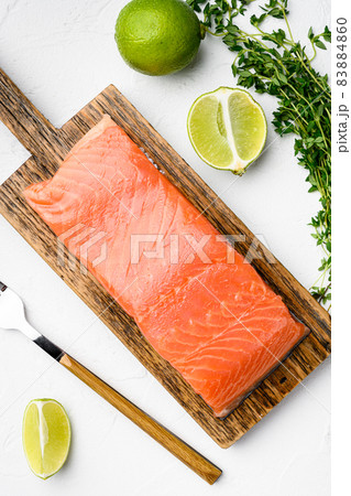 Salmon fillet fish, with herbs, on white stone table background, top view flat lay 83884860
