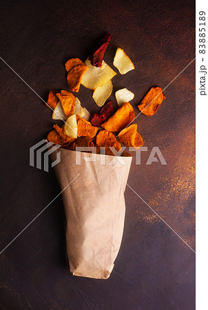 Succulent vegetable chips scattered from a kraft bag Succulent vegetable chips scattered from a kraft bag 83885189
