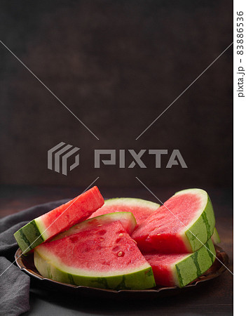 Red raw watermelon pieces on dark background 83886536