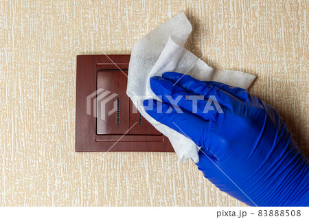 Disinfection and cleaning of light switches and home surfaces. The concept of preventive protection against coronavirus. Disinfection and cleaning of light switches and home surfaces. The concept of preventive protection against coronavirus. 83888508