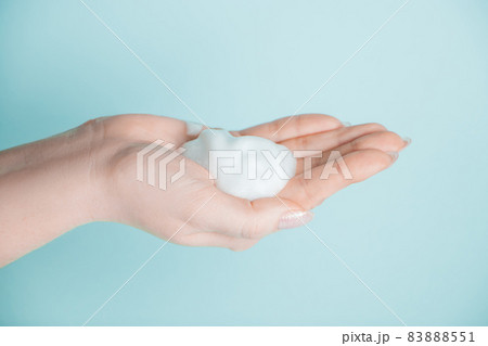 Soap foam in the hand. Coronavirus prevention concept, antiseptic on a blue background. Soap foam in the hand. Coronavirus prevention concept, antiseptic on a blue background. 83888551