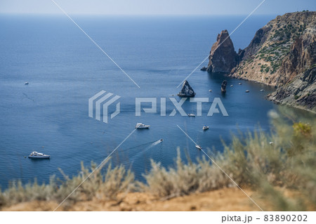 Fiolent , Crimea - sea landscape. Sea view - Mountains surround the bay and the small pleasure yacht boats moored in the lagoon 83890202