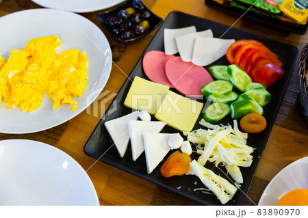 Turkish halal breakfast with cheese, sausages, eggs, vegetables, olives, sauces Turkish halal breakfast with cheese, sausages, eggs, vegetables, olives, sauces 83890970