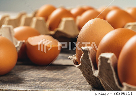 Chicken eggs in box on wooden table. 83896211