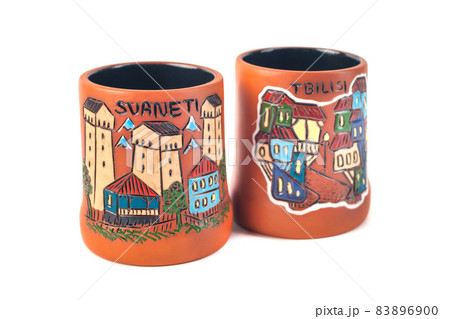 Georgian clay pottery with traditional ornaments on it. White background Georgian clay pottery with traditional ornaments on it. White background 83896900