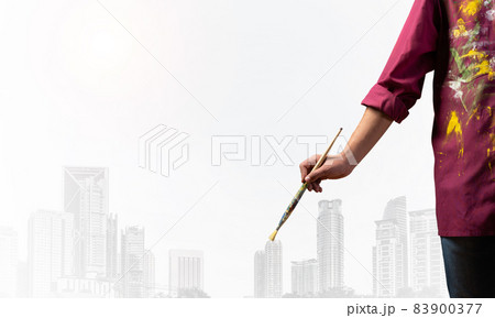Close up artist hand holding paintbrush Close up artist hand holding paintbrush 83900377