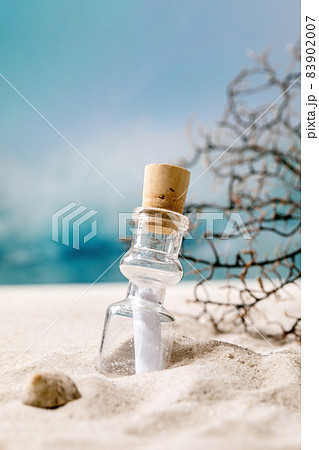 Summer sand sea beach with waves and glass botle with message 83902007